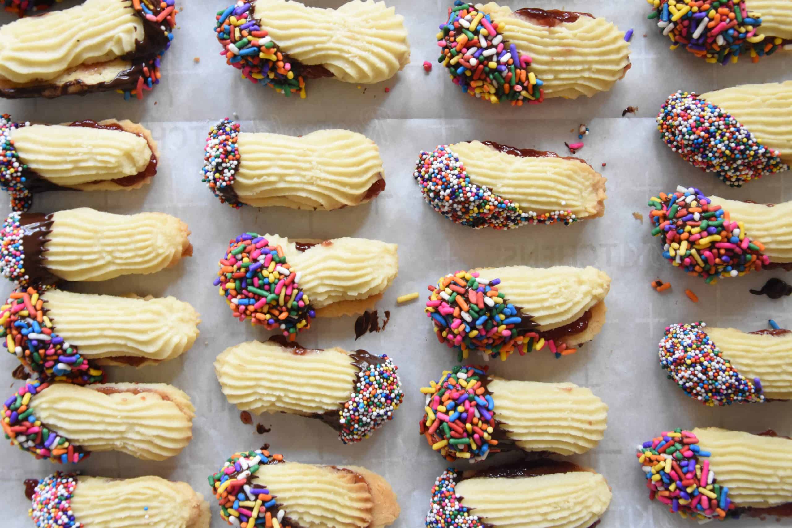 Cookies covered in chocolate and sprinkles