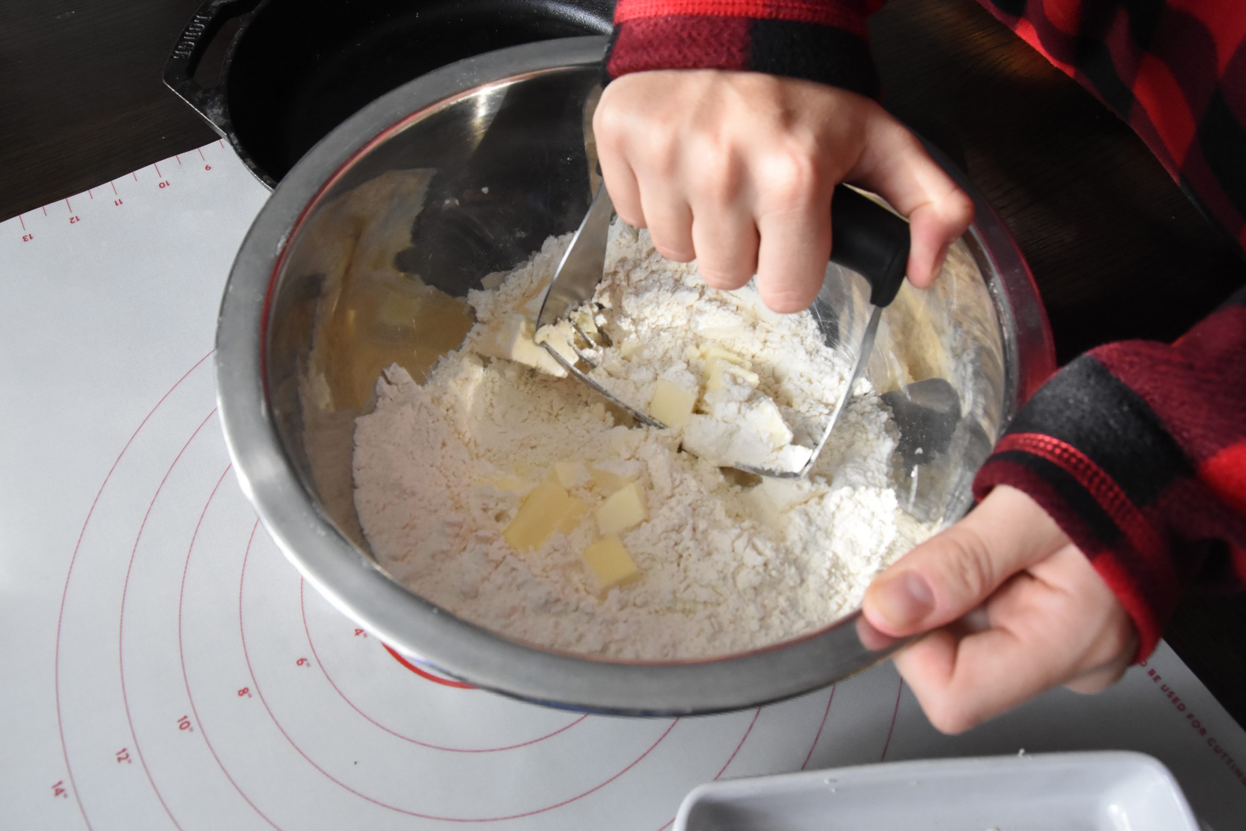 Butter being cut into flour for biscuits